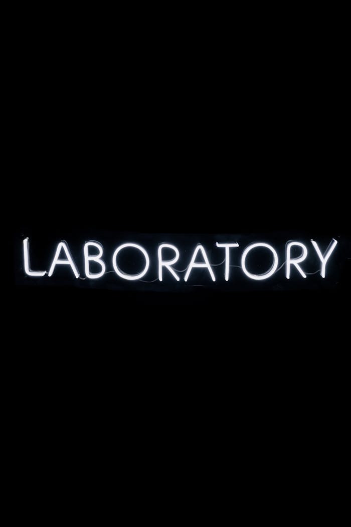 heros-img Illuminated neon sign displaying 'Laboratory' against a dark backdrop.